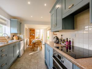 eine Küche mit blauen Schränken und einer Arbeitsplatte in der Unterkunft 3 bed property in Weybourne Norfolk KT069 in Weybourne