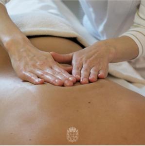 a woman with her hands on her stomach at Hotel Terme Marine Leopoldo II TERME & SPA in Marina di Grosseto
