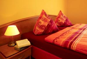 a bedroom with a bed with a lamp and a book at Haus Meerjungfrau in Ostseebad Karlshagen