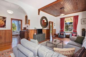 a living room with a couch and a table at Aranui palms - Mapua Holiday Home in Mapua