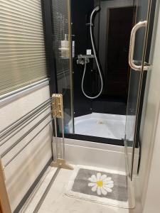 a bathroom with a shower with a sink and a bath tub at supiahouse in Tokyo