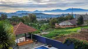 a house with a view of a city with mountains at Alessandra Villa in Lembang
