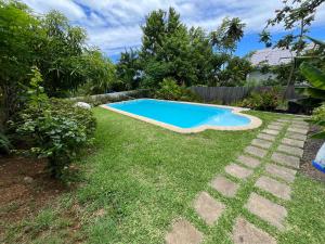 a swimming pool in the yard of a house at Spacious basement studio in tranquil nook in Rivière Noire
