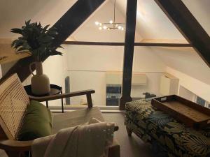 a living room with a couch and a table at Boutique, weaver’s cottage. Views in Bradford on Avon