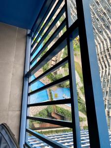 a window with a view of a building at Woodland Elegance Retreat Symphony of Artistry with Blazing fast 300 Mbps in Manila