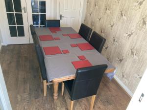 a dining room table with red squares on it at Quiet 3 bed semi with off street parking in Bingham