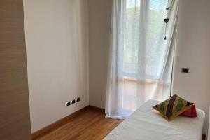 - une chambre avec un lit blanc et une fenêtre dans l'établissement Casa Il Cipresso, à Sant'Albino