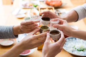 a group of people holding champagne glasses at a table at Berjaya Hakkoda Ski Resort in Aomori