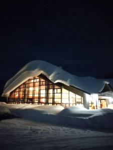 a building covered in snow at night at Berjaya Hakkoda Ski Resort in Aomori