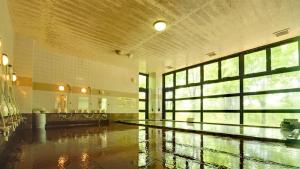 a large room with a pool in the middle of a building at Berjaya Hakkoda Ski Resort in Aomori +12 photos