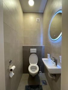 a bathroom with a toilet and a sink at Apartman Central in Banja Luka +8 photos