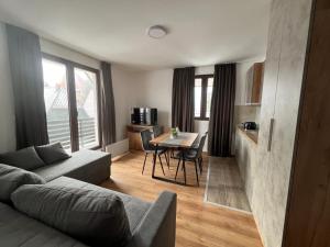 a living room with a couch and a table at Apartments SKY Kopaonik in Kopaonik