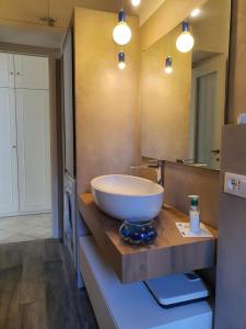 a bathroom with a large bowl sink on a wooden counter at Guest House Baia dei Sogni in Rapallo