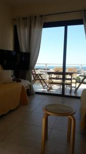 a living room with a table and a large window at The Best in Paphos City
