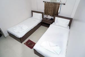 Postel nebo postele na pokoji v ubytování Sonar Bangla Guest House