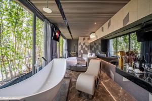a large bathroom with a tub and a bedroom at Bonita Signature The View in Ho Chi Minh City +25 photos