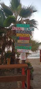 un cartel en una playa con una palmera en Andalusian Lifestyle en Marbella