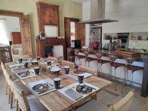a dining room with a table and a kitchen at Bastide Castella in Montpellier