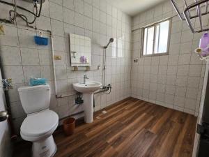 a bathroom with a toilet and a sink at Peace 28 B&B in Jincheng