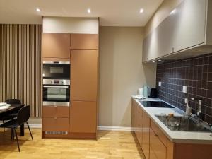 a kitchen with stainless steel appliances and a table at Central and modern in Oslo