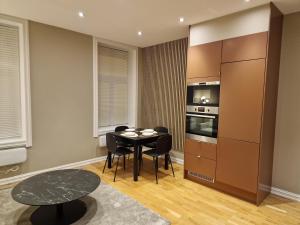 a kitchen with a table and a stove top oven at Central and modern in Oslo