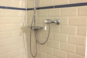 a shower with a hose in a bathroom at Chalupa Kolowrat in Horka