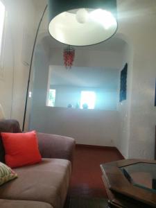 a living room with a couch and a lamp at Prime Rose in Saint-Aygulf