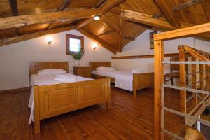 a bedroom with two beds and a bunk bed at Palaiopolis house in Avlemonas