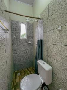 a bathroom with a toilet and a shower at Pousada Duna Village in Barreirinhas