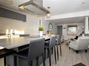 a kitchen and living room with a large island with chairs at 2 Bed in Cartmel 73154 in Cartmel