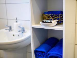 a bathroom with blue towels and a sink at 1 Bed in Harrogate 66981 in Knaresborough