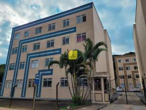 a large building with palm trees in front of it at Europe Garden Apartment, 3 quartos in Juiz de Fora