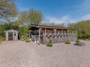 a house with a fence and a building at 1 bed in Exeter 75423 in Longdown