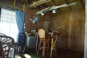 a kitchen with a bar with chairs and a stove at Salacia's Suite in Koh Rong Island
