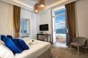 a bedroom with a bed and a view of the ocean at GOCCE VILLAS - Villa Degli Dei Waterfront Villa in Vico Equense
