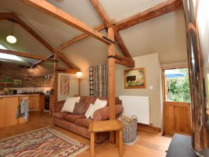 a living room with a couch and a kitchen at 2 bed in Presteigne 78095 in Presteigne