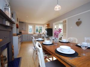 a kitchen and dining room with a wooden table and chairs at 3 Bed in Studland DC071 in Studland