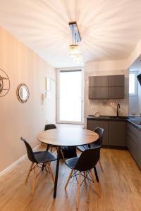 a dining room with a table and chairs in a kitchen at THE BASEMENT in Milan