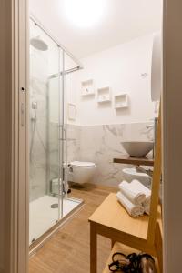 a bathroom with a glass shower and a toilet at THE BASEMENT in Milan