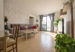 a living room with a couch and a table at Solymar in Chipiona