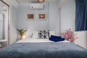 a bedroom with a large bed with blue blankets at Beach House Apartment, Playa Malagueta in Málaga