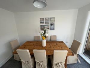 uma sala de jantar com uma mesa de madeira e cadeiras em Urban Retreat em Great Coates