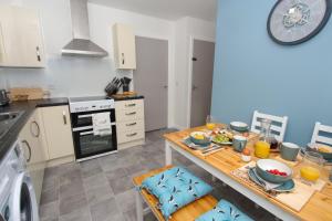 a kitchen with a table with food on it at Peedie Picky Townhoose - STL OR00094F in Orkney +5 photos