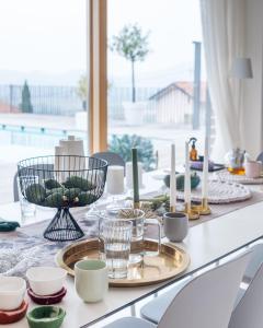 a dining room table with a table set with candles at Villa Alma Vista in Dobrovo +28 photos