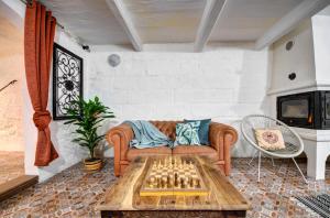 a living room with a couch and chessboard on a table at Boho Rooms Sliema in Sliema