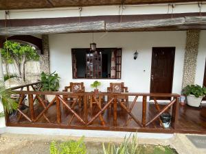 a porch of a house with a wooden deck at Tauig Beach Resort in Moalboal