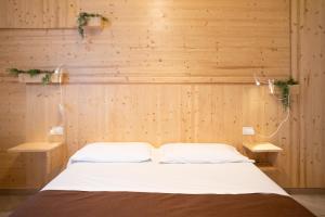 a bed in a room with wooden walls at B&B In Natura in Salerno