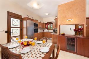 a kitchen with a table with fruit on it at Vlasis' Eden Villa in Sálakos