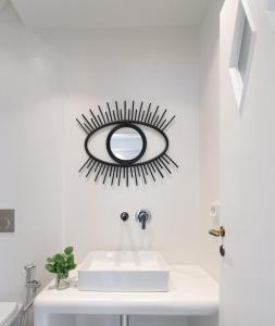 a bathroom with a mirror above a sink at Aeolos Villas Sustainable Living in Agkidia