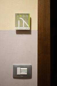 a sign on a wall with a mail box at B&B In Natura in Salerno
